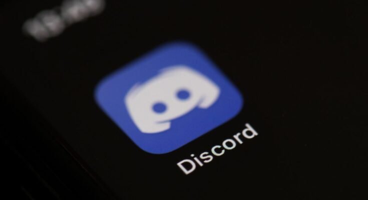 The logo of the social network application Discord on the screen of a phone.