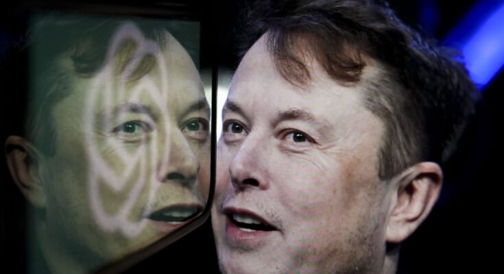In this photo illustration, the logo of 'OpenAI' is displayed on a mobile phone screen in front of a computer screen displaying the photograph of Elon Musk.