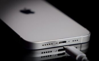 A Apple Lightning port charging cable is seen with with an iPhone.