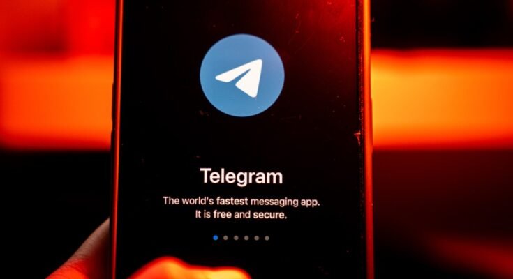 The logo for Telegram chat messenger application arranged on a smartphone.