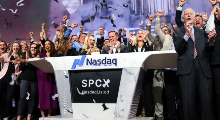Bret Johnsen (C), SpaceX Chief Financial Officer, and Gwynne Shotwell (center R), SpaceX President and Chief Operating Officer, celebrate as they ring the opening bell at the Nasdaq MarketSite to celebrate the launch of SpaceX’s initial public offering (IPO) in New York on June 12, 2026.