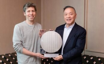 The CEOs of OpenAI and Broadcom stand flanking a circular semiconductor wafer.