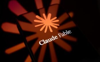 The Claude Fable logo is displayed on the screen of a smartphone placed on a reflective surface onto which the company's icon is projected.