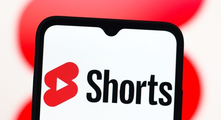 In this photo illustration, the YouTube Shorts logo is seen displayed on a smartphone screen.