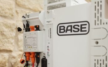 A Base Power battery sits next to a home.