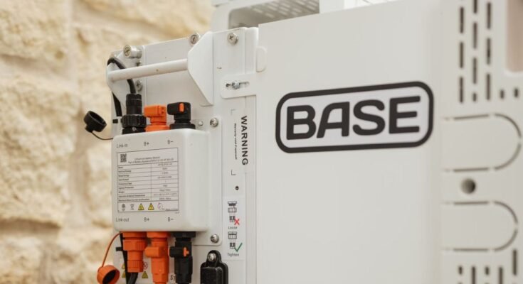 A Base Power battery sits next to a home.